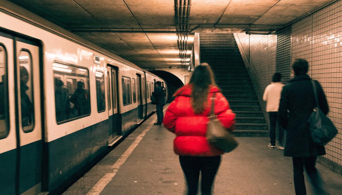 Eine S-Bahn steht mit geoeffneten Tueren an einem unterirdischen Bahnsteig