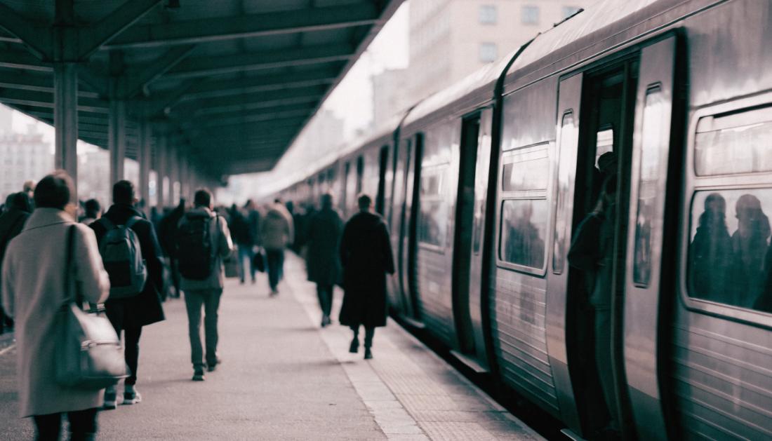 Pendler steigen morgens an einem Stadtbahnsteig in einen Zug