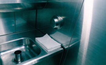 Waschbecken und Bedienknopf in einer modernen Zugtoilette