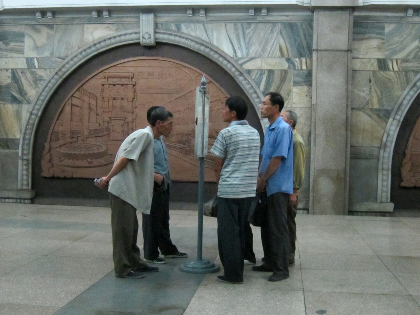 Public newspaper reading stand in Pyongyang metro 2