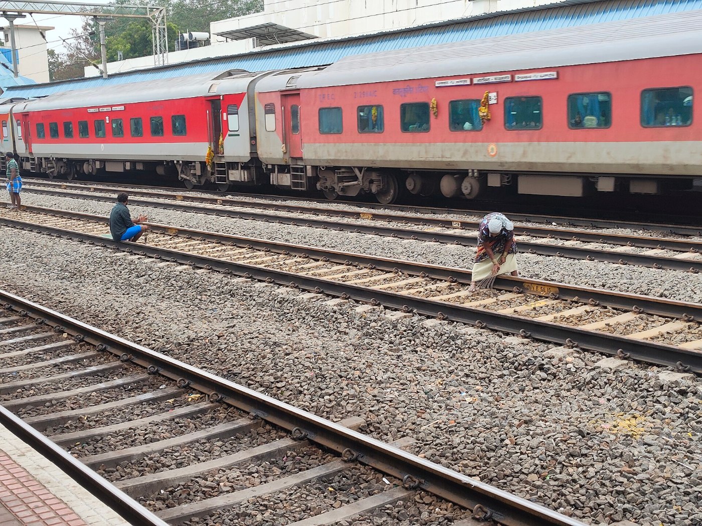 Workers manually levelling gravel (Ballast) in the railway track, Tamil