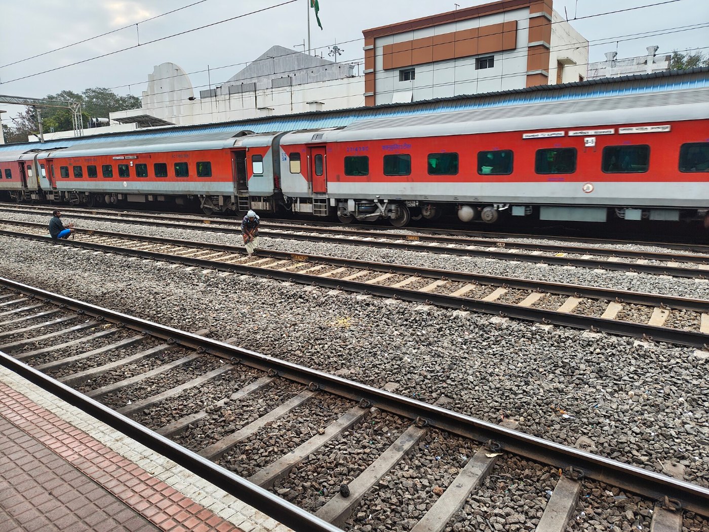Workers manually levelling gravel (Ballast) in the railway track, Tamil