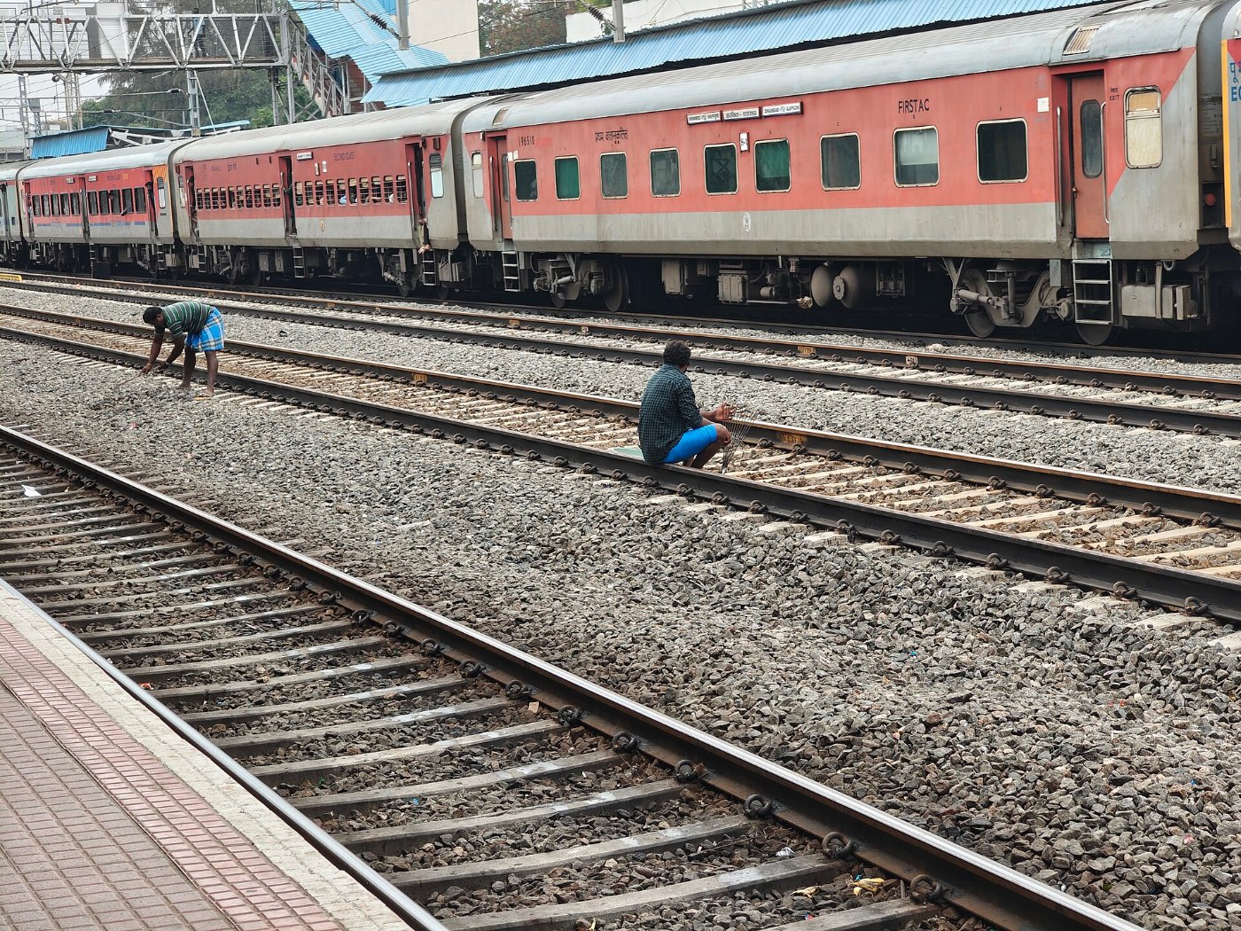 Workers manually levelling gravel (Ballast) in the railway track, Tamil 