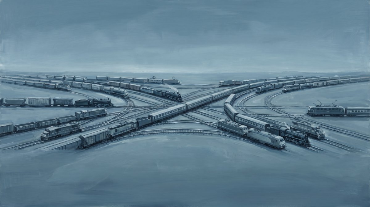 Ein weites Bahnnetz von oben, auf dem viele verschiedene Züge gemeinsam unterwegs sind