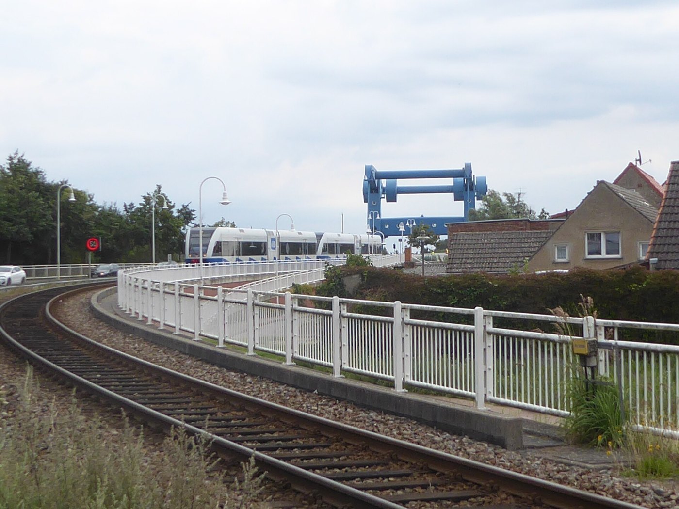Train approaches Wolgast road rail bascule bridge, 24 August 2020