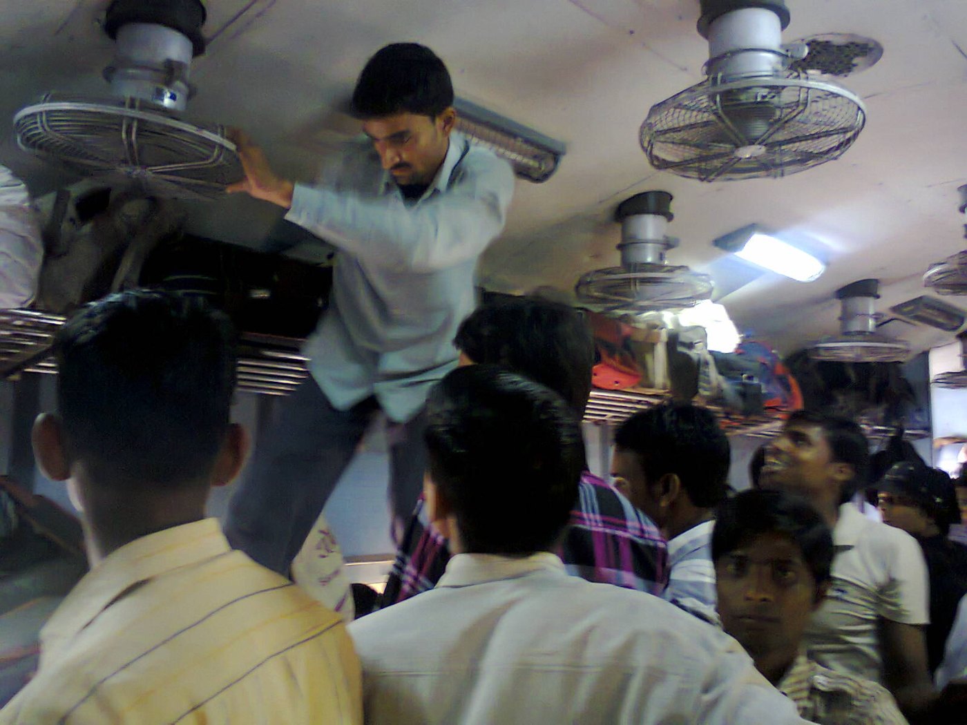 Man rushing to toilet in an over conjusted general coach in Indian Railw