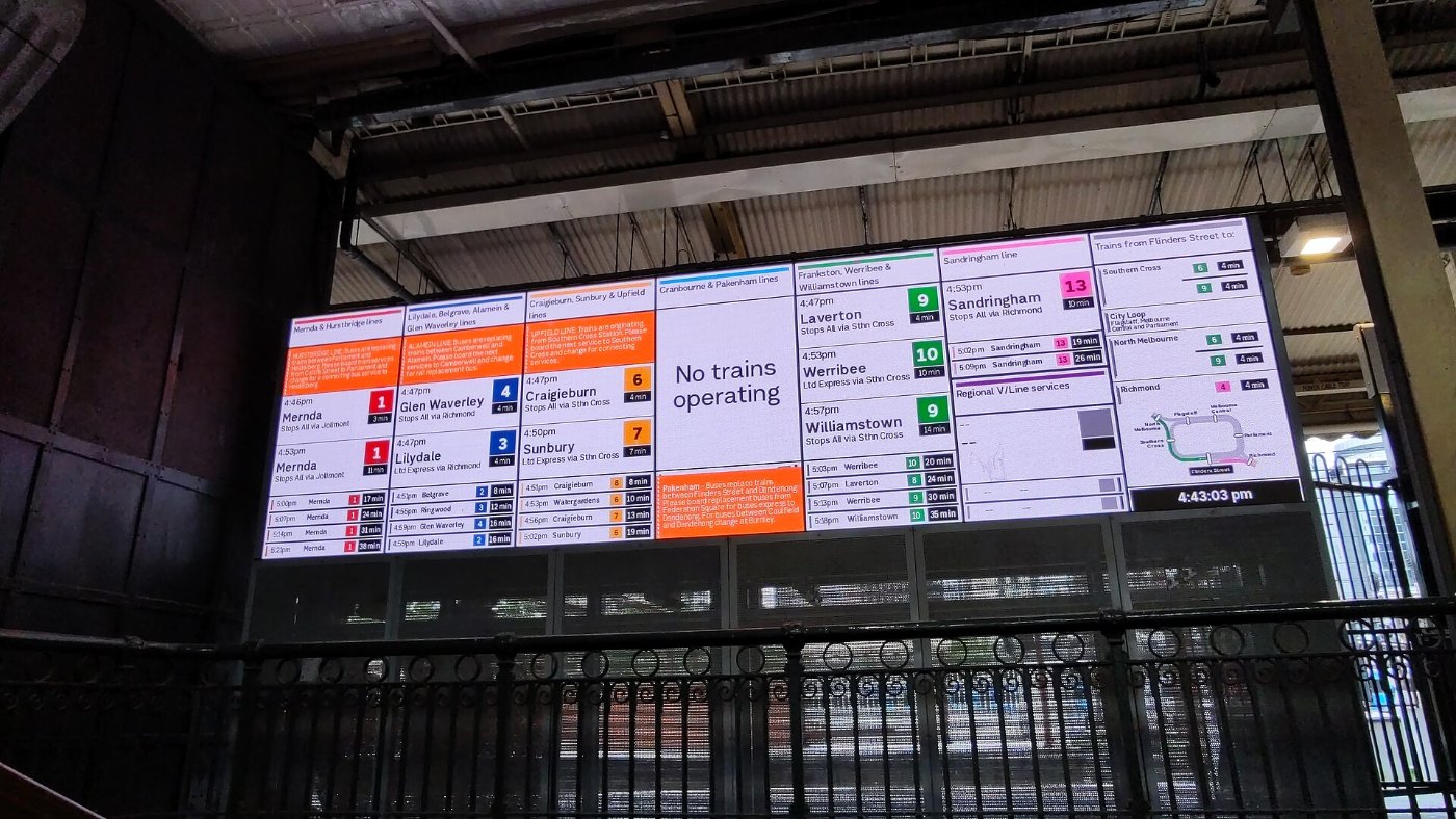 Train departure screens with disruption information facing Elizabeth Str