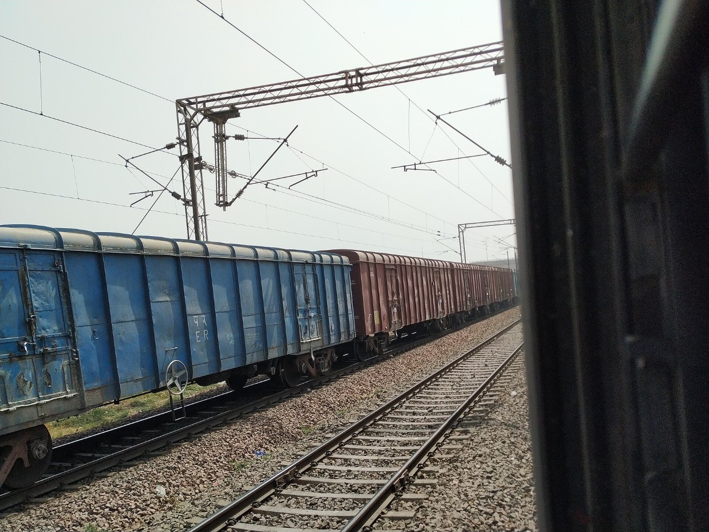 Blue and red colored coaches of a freight train in India