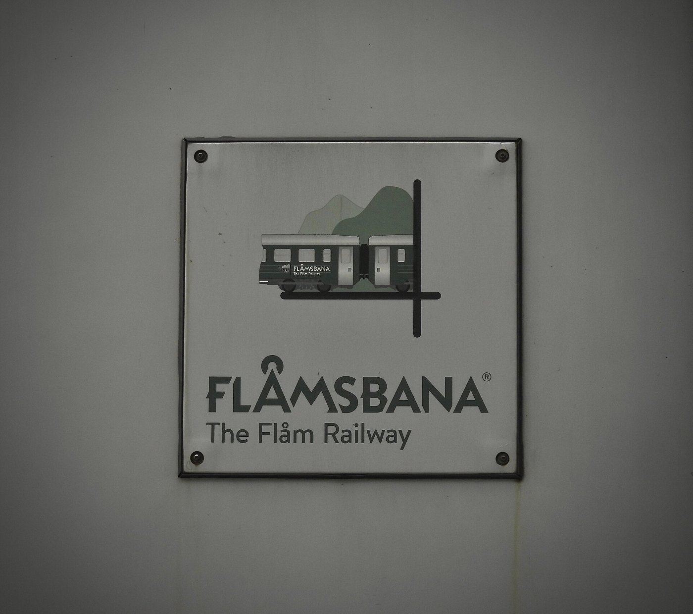 Flåmsbana The Flåm Railway reads the white & green placard