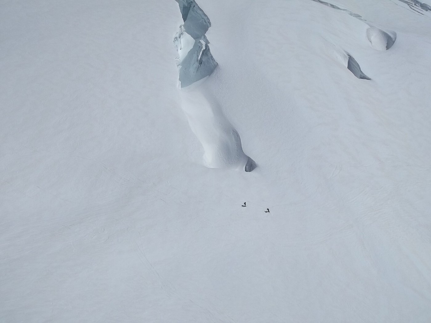 Two alpinists next to a crevasse on the Jungfraujoch