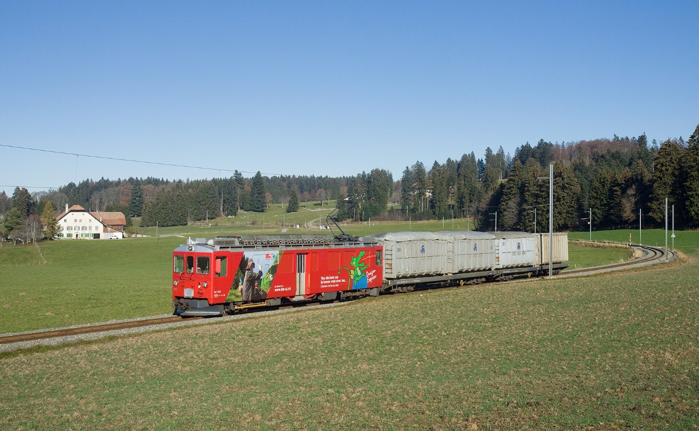 CJ ABe 4 4 with a waste train near La Ferrière